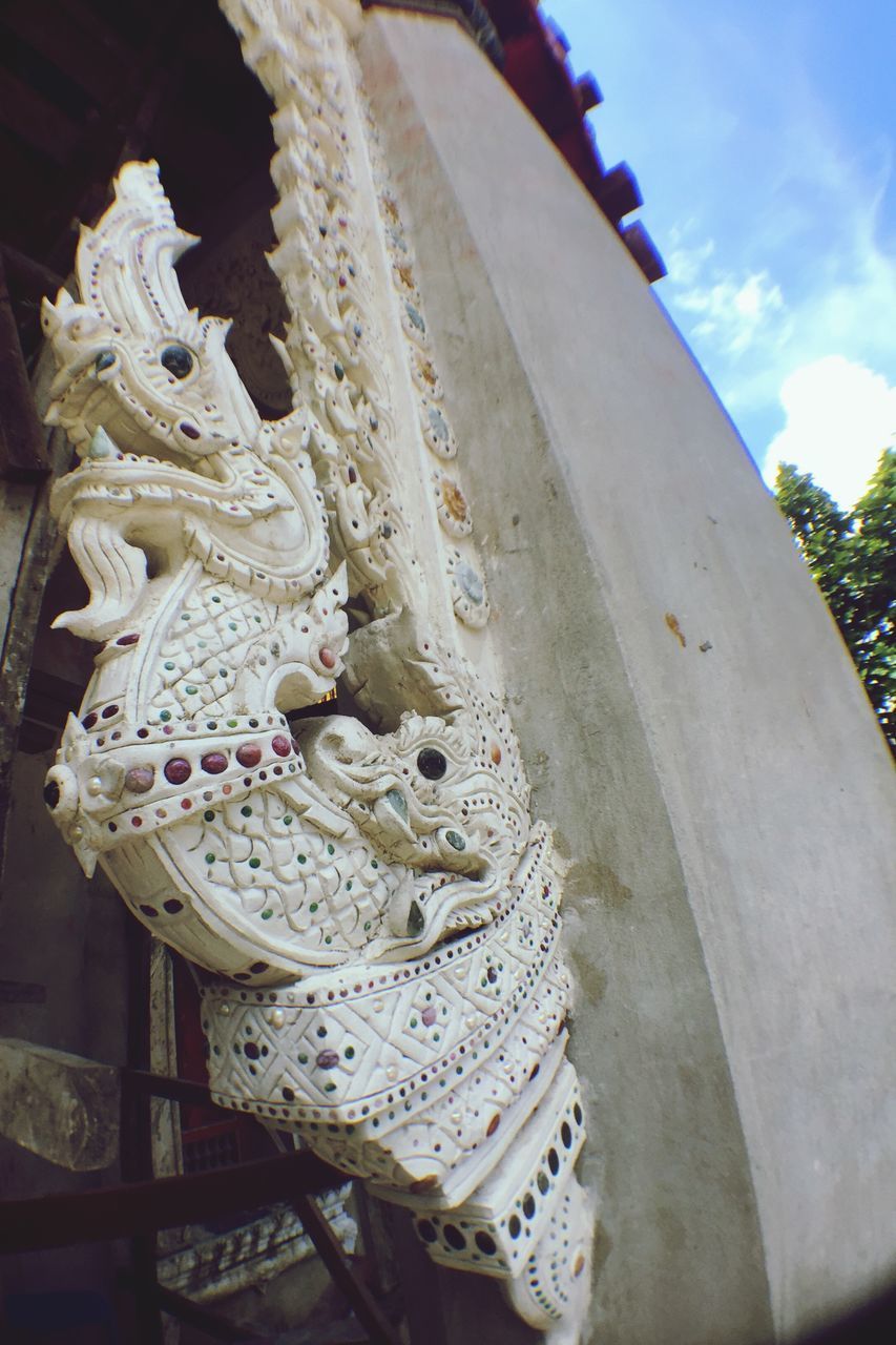 LOW ANGLE VIEW OF A STATUE OF A TEMPLE