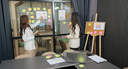 Portrait of woman using mobile phone in office