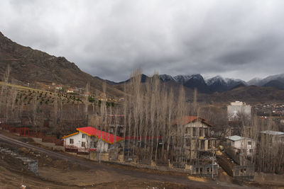 Panoramic view of buildings and mountains against sky