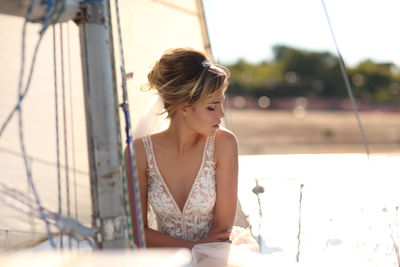 Bride on a sailing yacht in the rays of the setting sun