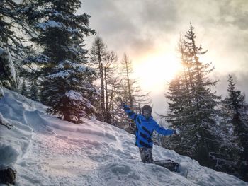 Woman standing on snow covered mountain