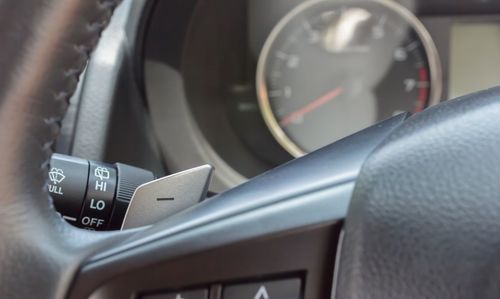 Close-up of hand on car windshield