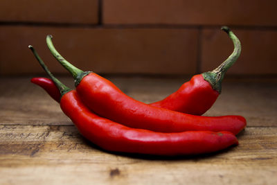 Close-up of red chili peppers on table