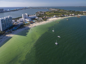 High angle view of buildings by sea against sky