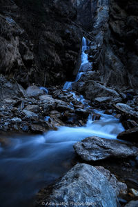 Stream flowing through rocks in forest