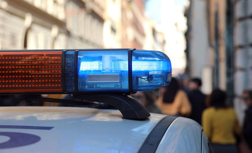 Patrol police car with blue light of sirens in the city