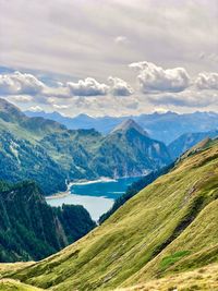 Scenic view of lake and mountains against sky