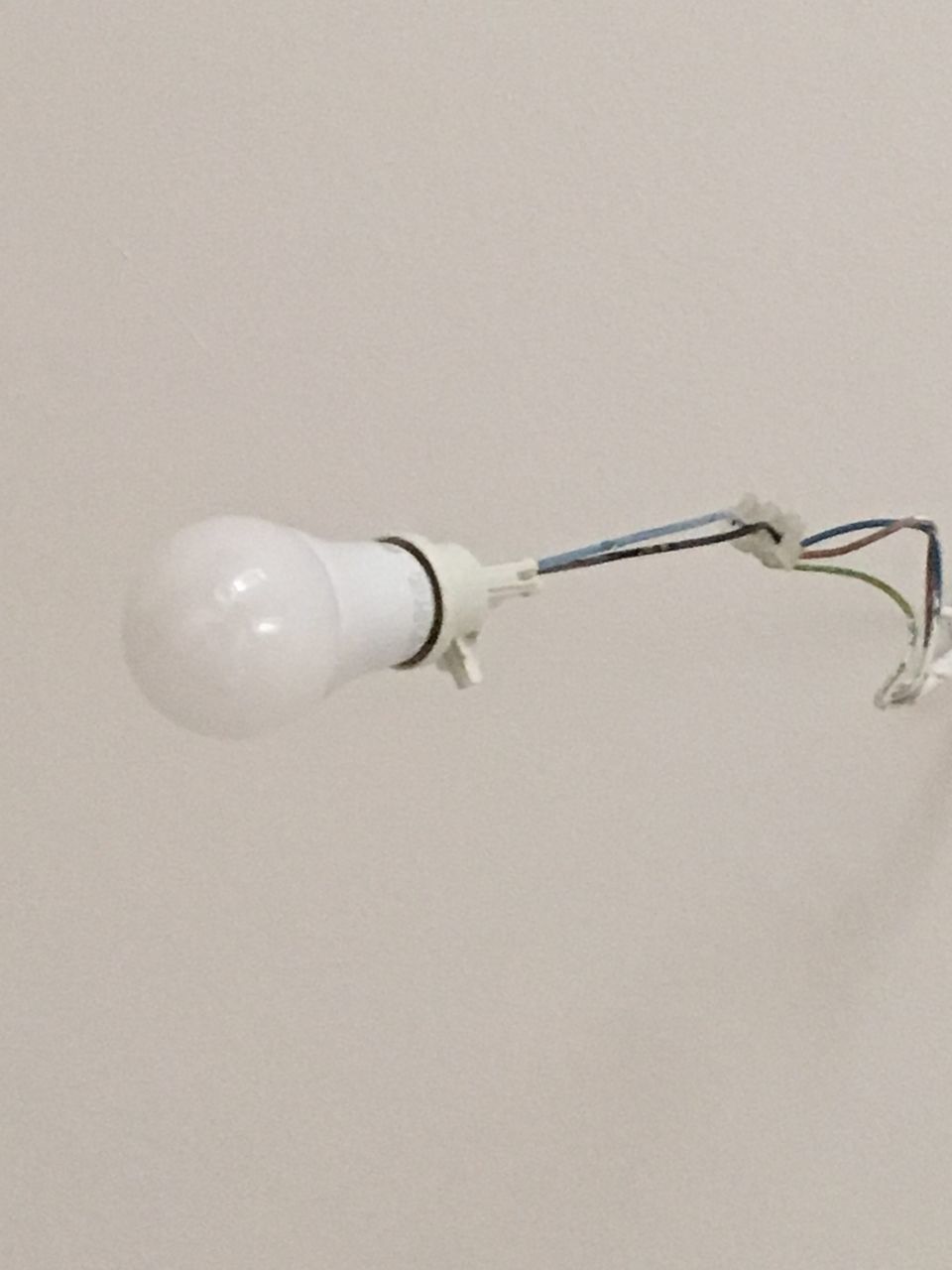 CLOSE-UP OF LIGHT BULB ON WHITE BACKGROUND