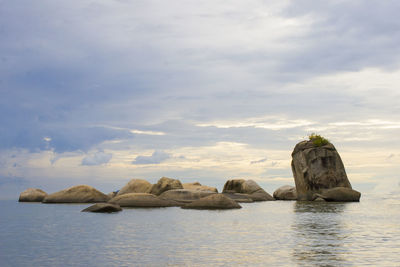 Rocks on sea against sky