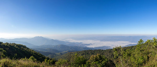 Scenic view of mountains against clear blue sky