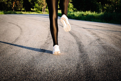 Low section of woman on road