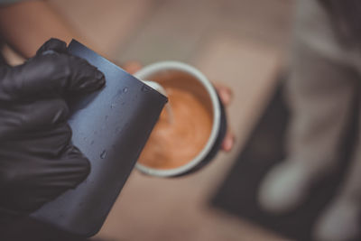 Midsection of man holding coffee