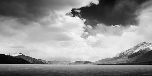 Scenic view of mountains against cloudy sky