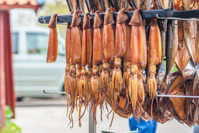 Hanging smoke-dried calamari in a fish market smoked with hardwood wood chips in a smoker