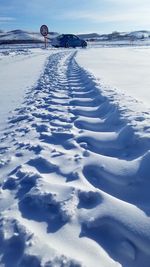 Snow covered land against sky