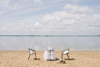 Table and chair for a romantic dinner by the sea, lake or ocean for a honeymoon