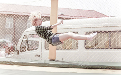 Young woman jumping on trampoline