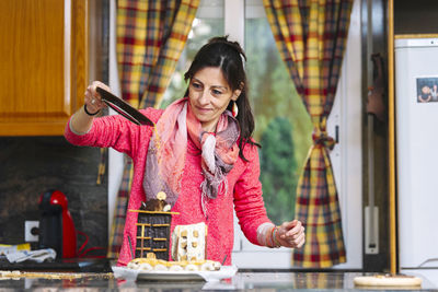 Portrait of a smiling young woman holding food