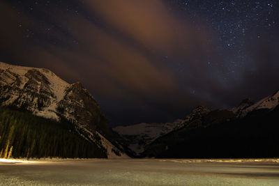 Scenic view of mountains against sky at night