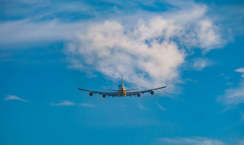 Low angle view of airplane flying in sky