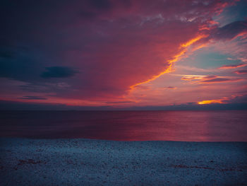 Scenic view of sea against romantic sky at sunset
