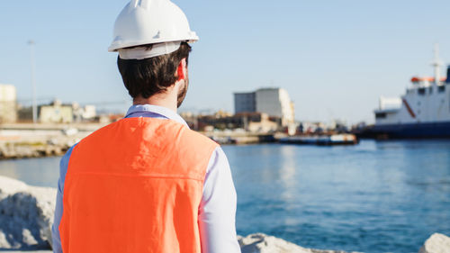 Naval engineer quality check in the port in a city near the ocean