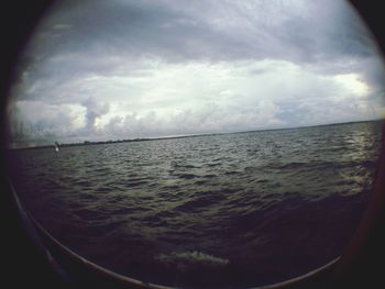 Scenic view of sea against cloudy sky