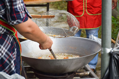 Midsection of man preparing food