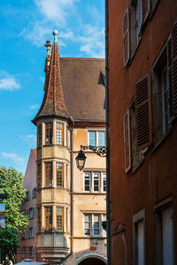 Low angle view of old building in town against sky