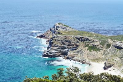 High angle view of rocks on sea shore