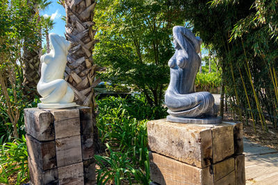 Statue against trees and plants