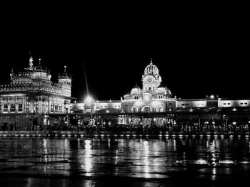 Reflection of illuminated buildings in city at night