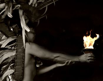 Close-up of woman holding burning fire