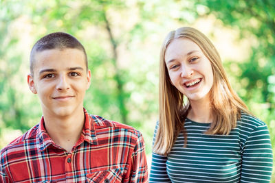 Portrait of smiling young woman standing outdoors