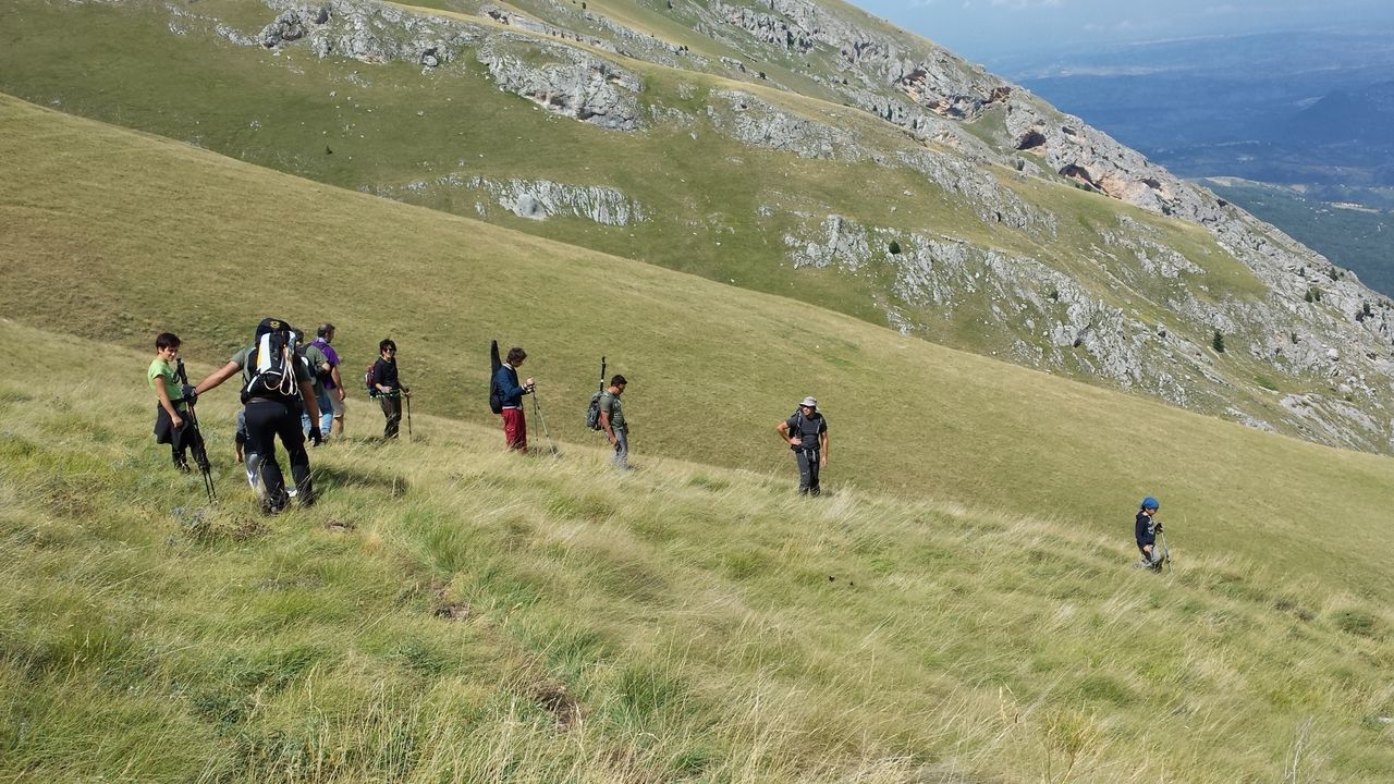 leisure activity, lifestyles, water, men, grass, mountain, person, togetherness, vacations, nature, large group of people, tranquility, beauty in nature, lake, scenics, tranquil scene, tourist, green color