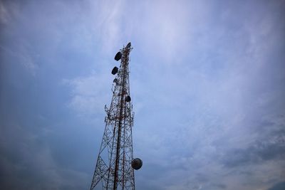 Low angle view of communications tower against sky