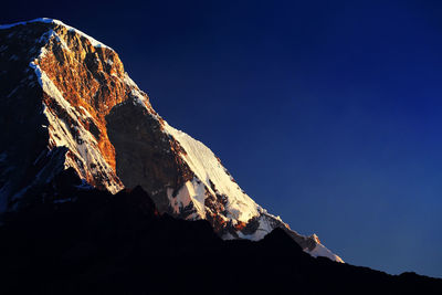 Snowcapped mountain against blue sky