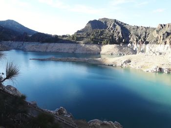 Scenic view of lake and mountains against sky