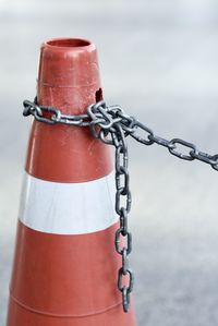 Close-up of chain on traffic cone at street