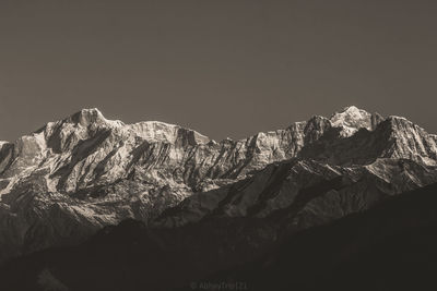 Scenic view of snowcapped mountains against clear sky