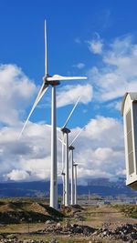 Windmill on field against sky