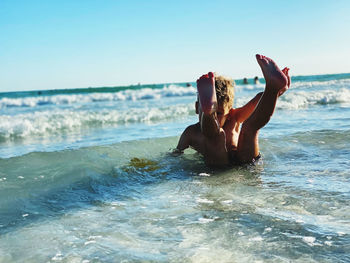 A boy is playing on the beach