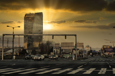 Traffic on road at sunset