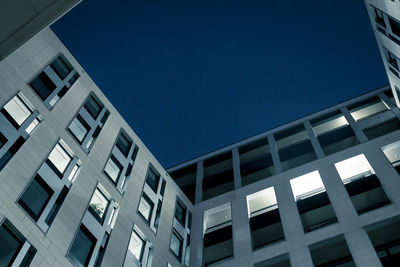 Low angle view of modern building against clear blue sky