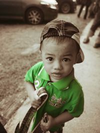 Portrait of cute boy holding toy