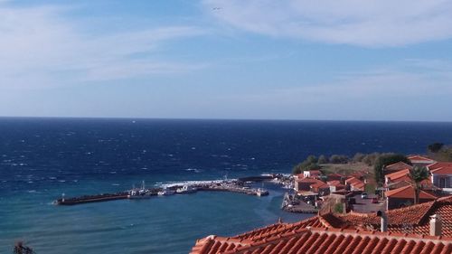 High angle view of sea and buildings against sky