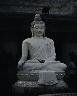 Statue of buddha against building