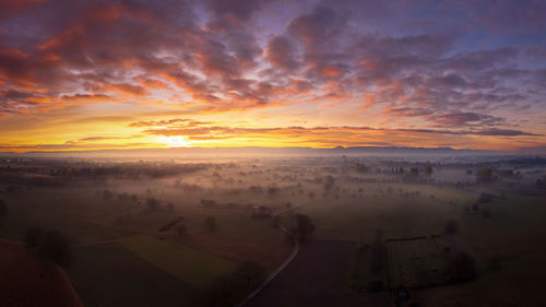 Colourful sunrise over the rhine plain near rastatt on a foggy autumn morning