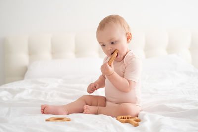 Cute baby boy sleeping on bed at home