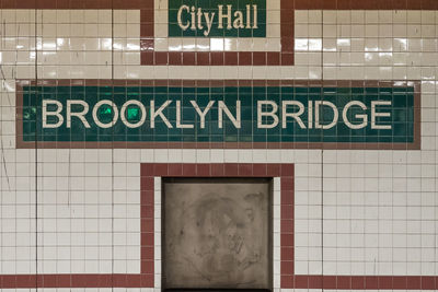 Close-up of text on wall at subway station